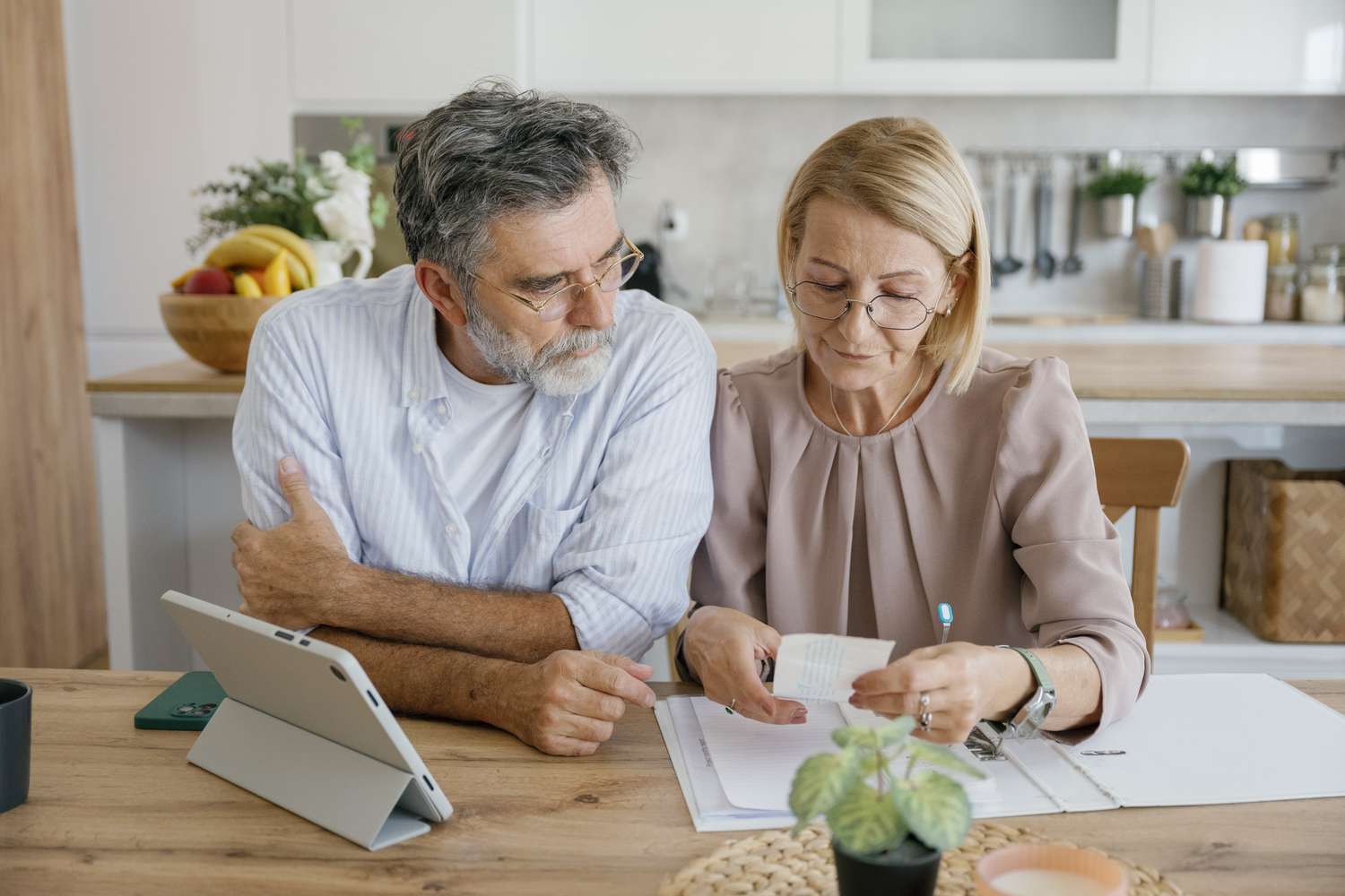 A couple in their early fifties reviewing their financial plan together at home